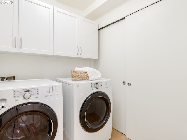 790 NW Westover Sq Unit 8, Portland, OR 97210 - laundry room with cabinet space, separate washer and dryer, and light wood-type flooring