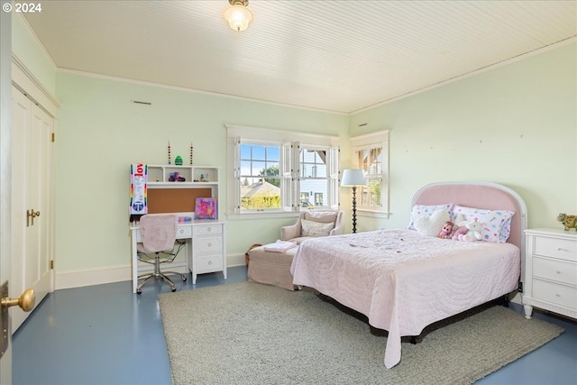 bedroom featuring concrete flooring and crown molding