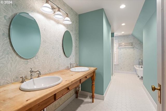 bathroom featuring vanity, tile patterned floors, and a bathtub