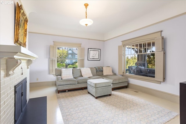 living room featuring a brick fireplace