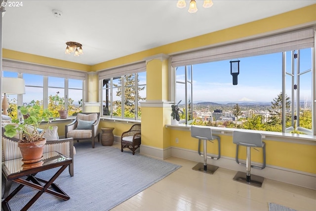 sunroom with a wealth of natural light and a mountain view