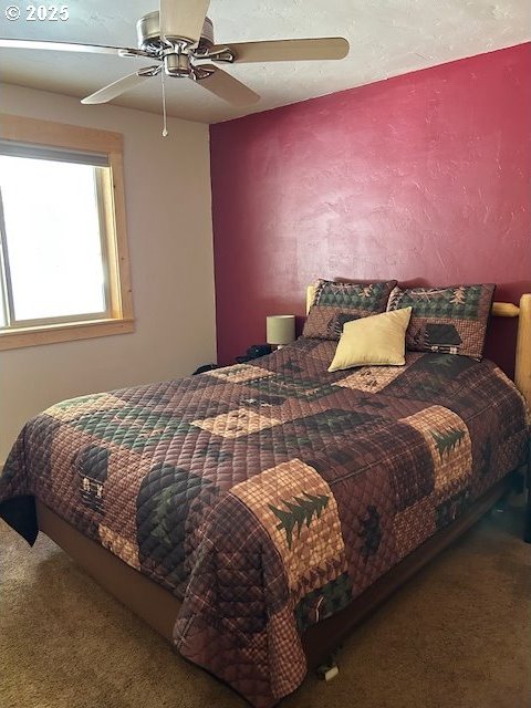 bedroom featuring ceiling fan and carpet floors