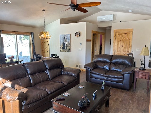 living room featuring lofted ceiling, wood finished floors, visible vents, and ceiling fan