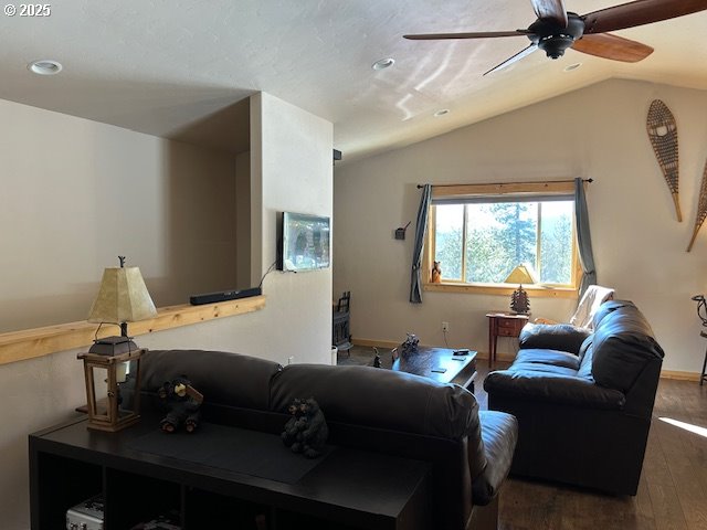 living room featuring ceiling fan, lofted ceiling, and wood finished floors