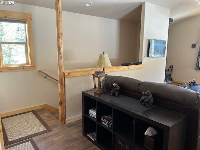 interior space with baseboards and wood finished floors