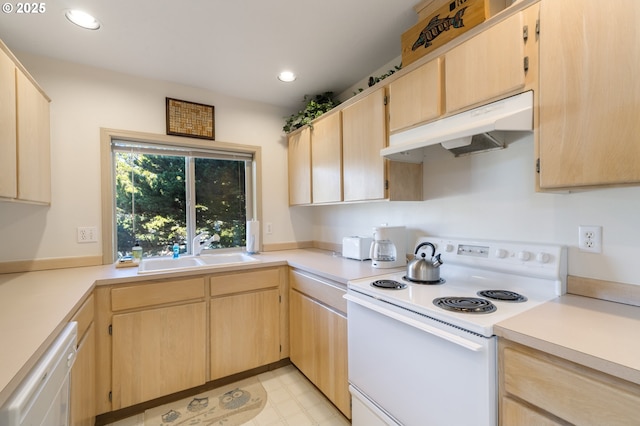 kitchen with light brown cabinetry, sink, and white appliances