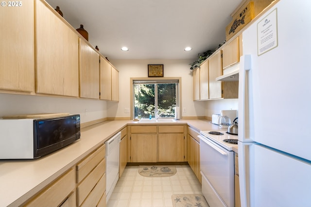 kitchen featuring sink, light brown cabinetry, and white appliances