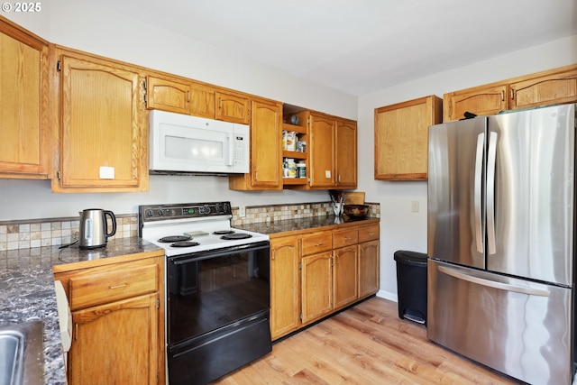 722 E 14th St, The Dalles, OR 97058 - kitchen featuring freestanding refrigerator, range with electric stovetop, white microwave, open shelves, and light wood-style floors