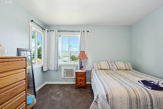 722 E 14th St, The Dalles, OR 97058 - bedroom with dark carpet, a wall mounted air conditioner, and baseboards