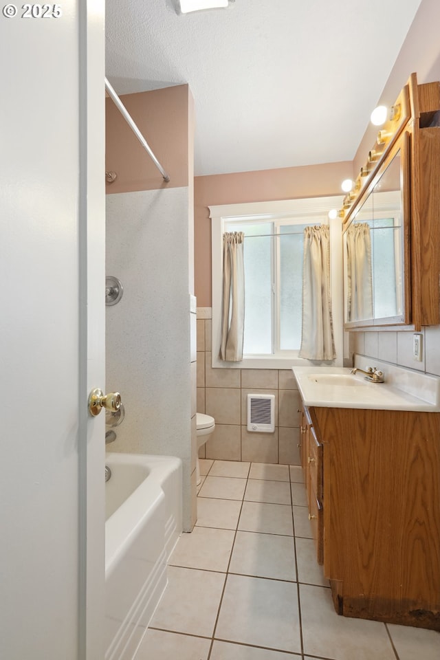 722 E 14th St, The Dalles, OR 97058 - bathroom with tile patterned flooring, vanity, bathtub / shower combination, tile walls, and toilet