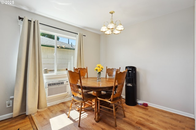 722 E 14th St, The Dalles, OR 97058 - dining space with a chandelier, light wood-type flooring, baseboards, and an AC wall unit