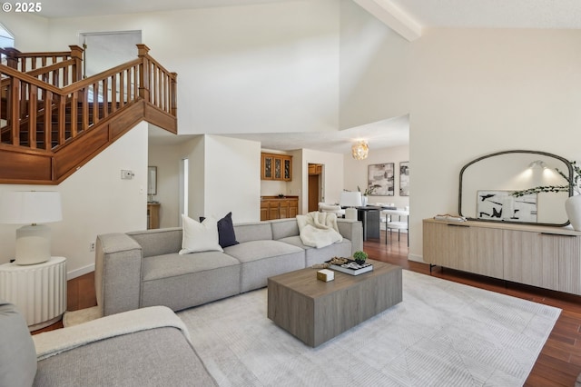 950 NW 161st Ter, Beaverton, OR 97006 - living area featuring high vaulted ceiling, stairs, wood finished floors, beamed ceiling, and a notable chandelier