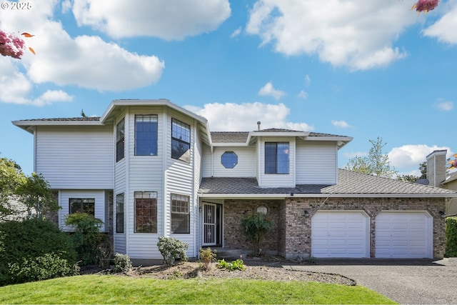 950 NW 161st Ter, Beaverton, OR 97006 - traditional-style house featuring brick siding, aphalt driveway, and a garage