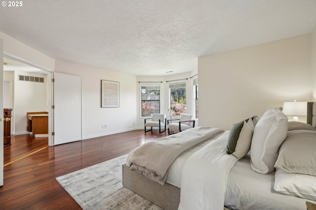 950 NW 161st Ter, Beaverton, OR 97006 - bedroom featuring hardwood / wood-style flooring, baseboards, a textured ceiling, and visible vents