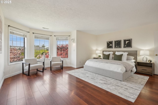 950 NW 161st Ter, Beaverton, OR 97006 - bedroom featuring baseboards, a textured ceiling, and dark wood finished floors