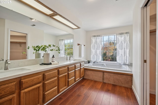 950 NW 161st Ter, Beaverton, OR 97006 - bathroom featuring a bath, a wealth of natural light, and a sink