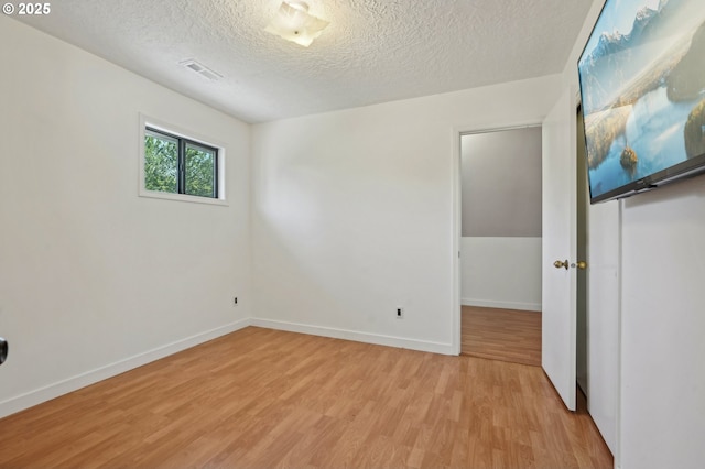 950 NW 161st Ter, Beaverton, OR 97006 - spare room with baseboards, visible vents, a textured ceiling, and light wood-style floors