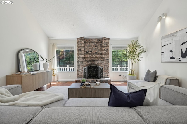 950 NW 161st Ter, Beaverton, OR 97006 - living room with lofted ceiling, a brick fireplace, wood finished floors, and a healthy amount of sunlight
