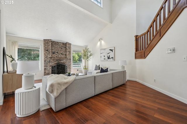 950 NW 161st Ter, Beaverton, OR 97006 - living room featuring a fireplace, a healthy amount of sunlight, and hardwood / wood-style flooring