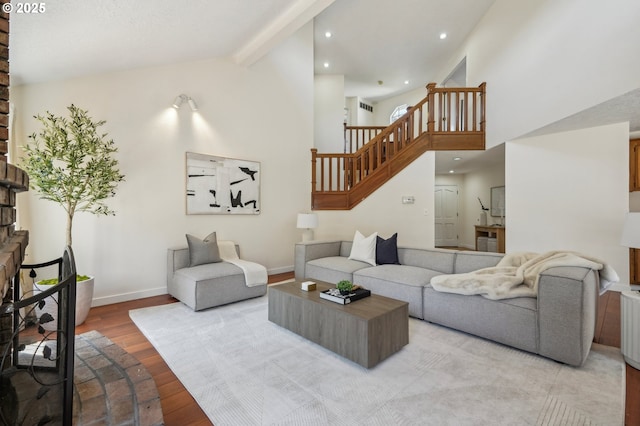 950 NW 161st Ter, Beaverton, OR 97006 - living room featuring stairway, wood finished floors, beamed ceiling, baseboards, and high vaulted ceiling
