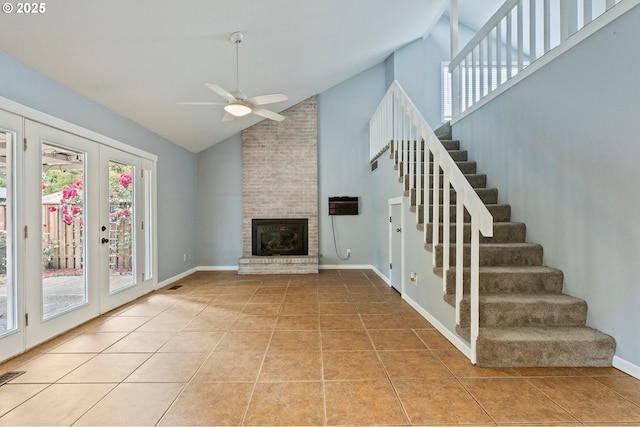 4935 NW Kahneeta Ct, Portland, OR 97229 - unfurnished living room featuring ceiling fan, high vaulted ceiling, light tile patterned floors, stairs, and a fireplace