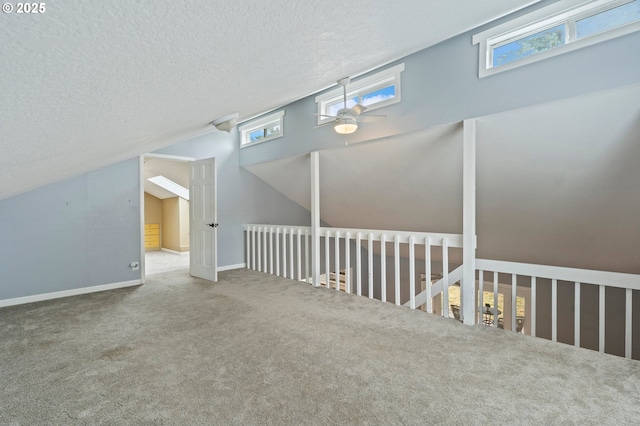4935 NW Kahneeta Ct, Portland, OR 97229 - additional living space featuring ceiling fan, carpet flooring, healthy amount of natural light, a textured ceiling, and lofted ceiling