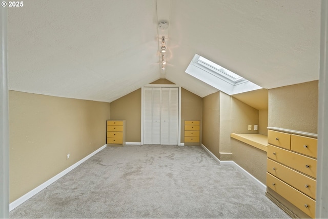 4935 NW Kahneeta Ct, Portland, OR 97229 - additional living space with a skylight, vaulted ceiling, and carpet