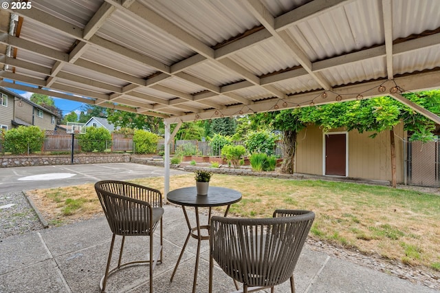 4935 NW Kahneeta Ct, Portland, OR 97229 - fenced backyard featuring a patio and an outbuilding