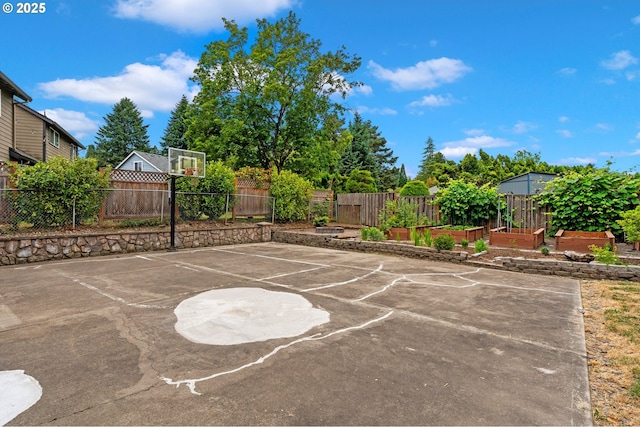 4935 NW Kahneeta Ct, Portland, OR 97229 - fenced backyard featuring basketball court and a vegetable garden