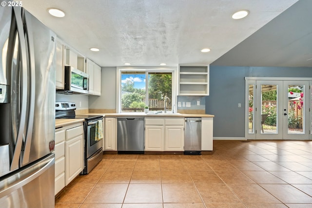 4935 NW Kahneeta Ct, Portland, OR 97229 - kitchen with appliances with stainless steel finishes, light countertops, recessed lighting, open shelves, and light tile patterned floors