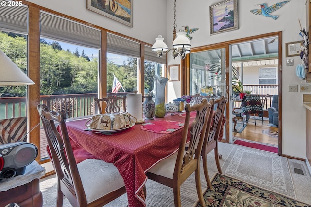 3419 S Ballard Ln, Lincoln City, OR 97367 - carpeted dining room with a chandelier