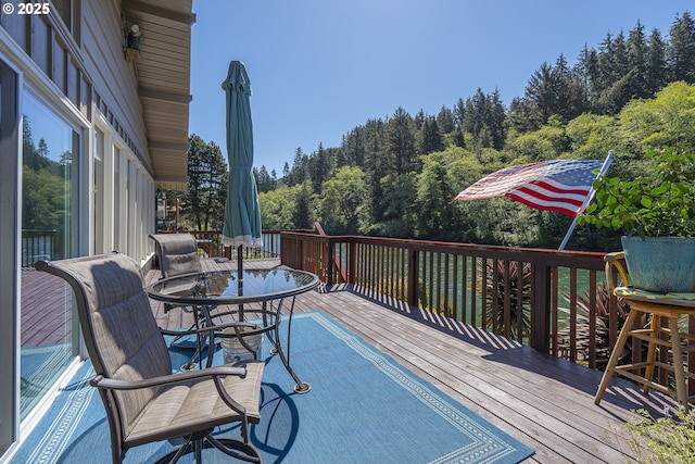 3419 S Ballard Ln, Lincoln City, OR 97367 - deck featuring outdoor dining area and a wooded view