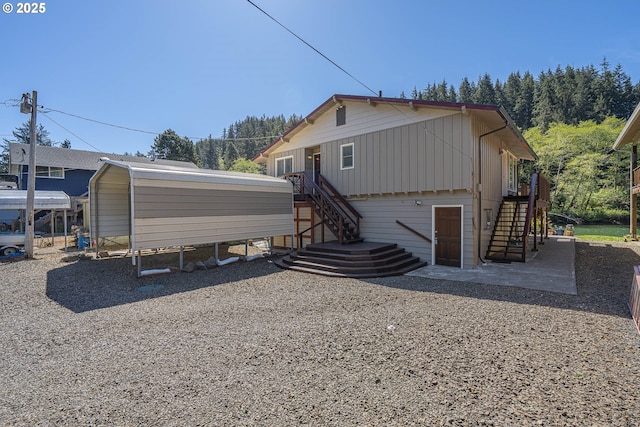 3419 S Ballard Ln, Lincoln City, OR 97367 - back of house featuring stairway and board and batten siding