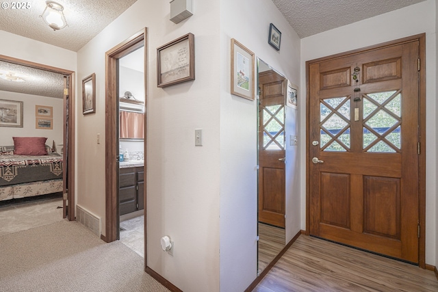 3419 S Ballard Ln, Lincoln City, OR 97367 - foyer entrance with a textured ceiling and baseboards