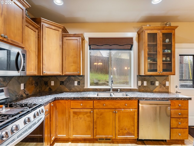 kitchen featuring decorative backsplash, sink, and appliances with stainless steel finishes