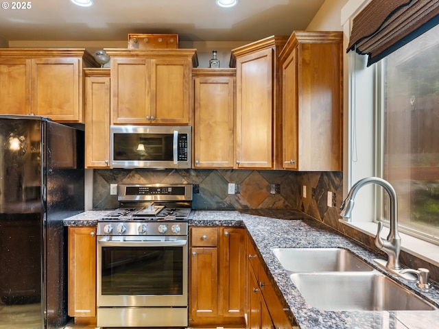 kitchen featuring decorative backsplash, sink, and appliances with stainless steel finishes