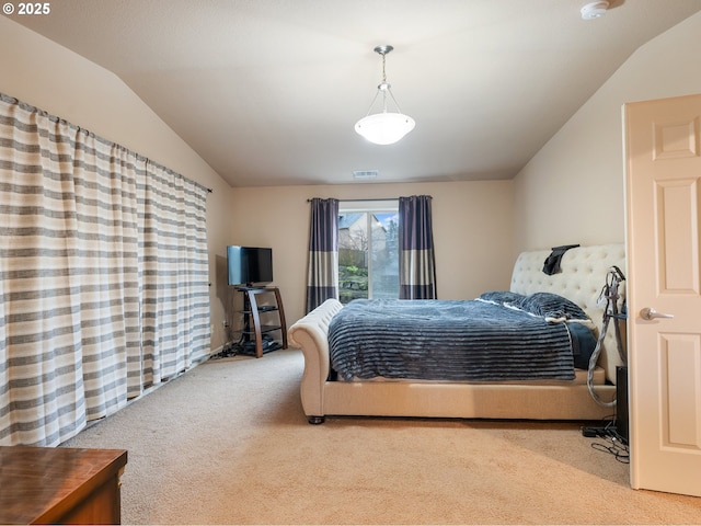 bedroom featuring lofted ceiling and light carpet