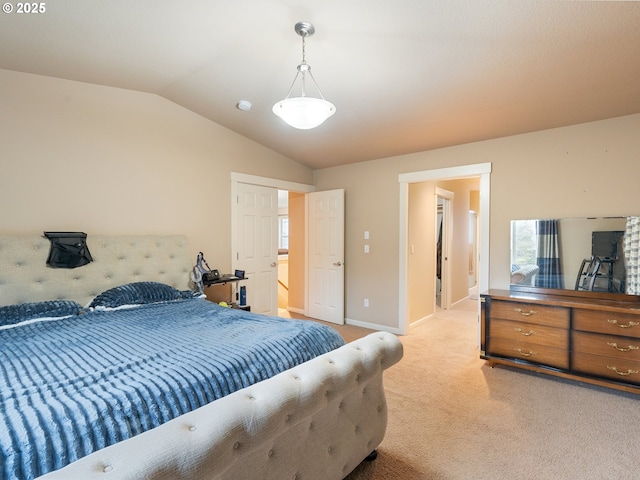 carpeted bedroom featuring lofted ceiling