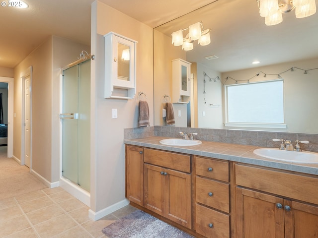 bathroom with vanity, tile patterned floors, and a shower with door