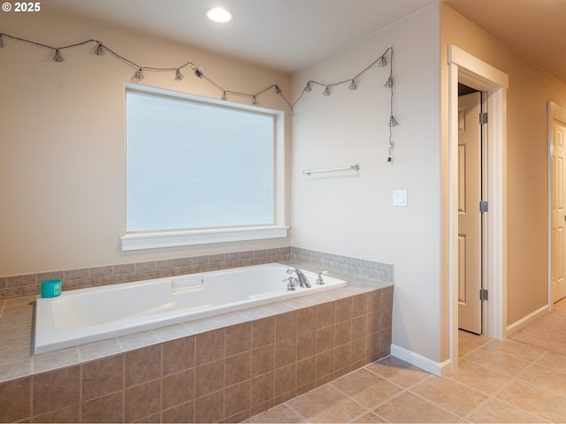 bathroom featuring tile patterned floors and tiled bath