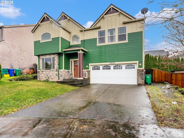 view of front of home with a front yard and a garage