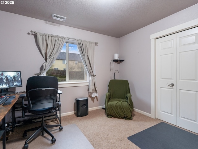 home office with carpet floors and a textured ceiling