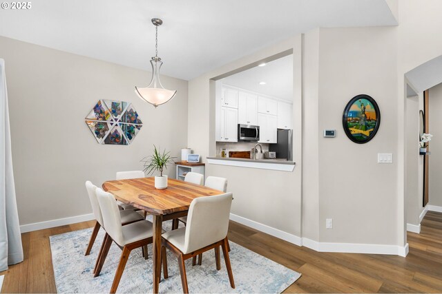 9619 NW Silver Ridge Loop, Portland, OR 97229 - dining area with baseboards, wood finished floors, and recessed lighting