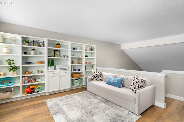 9619 NW Silver Ridge Loop, Portland, OR 97229 - living area with light wood finished floors, vaulted ceiling, and baseboards