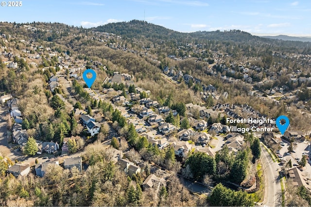 9619 NW Silver Ridge Loop, Portland, OR 97229 - aerial overview of property's location with mountains, nearby suburban area, and a heavily wooded area