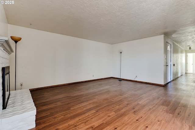 786788 W Quinalt St, Springfield, OR 97477 - unfurnished living room featuring wood finished floors and a brick fireplace