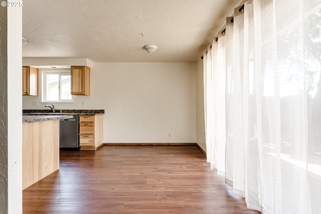 786788 W Quinalt St, Springfield, OR 97477 - kitchen featuring stainless steel dishwasher, dark countertops, wood finished floors, and light brown cabinetry