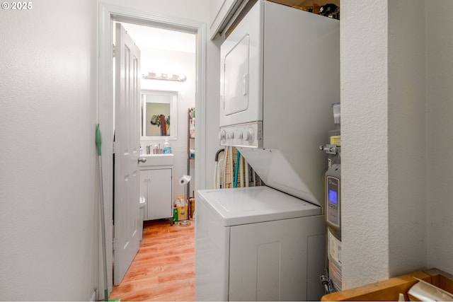 1910 SW 18th Ave Unit 23, Portland, OR 97201 - laundry area featuring stacked washer / drying machine and light wood-style flooring