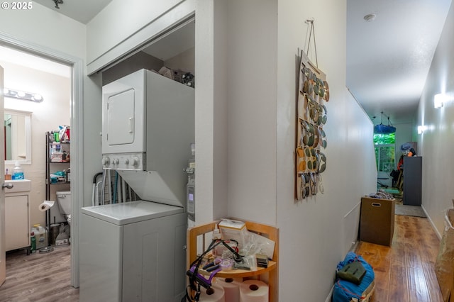 1910 SW 18th Ave Unit 23, Portland, OR 97201 - washroom featuring stacked washer / dryer and light wood-type flooring