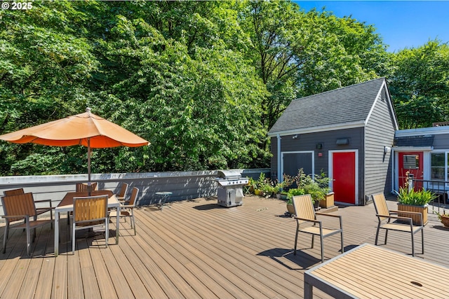 1910 SW 18th Ave Unit 23, Portland, OR 97201 - wooden deck featuring outdoor dining space, area for grilling, and view of wooded area